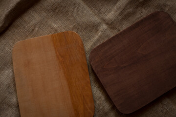 Selected focus empty brown wooden table top on burlap, blurred background image. For your photomontage or product demonstration