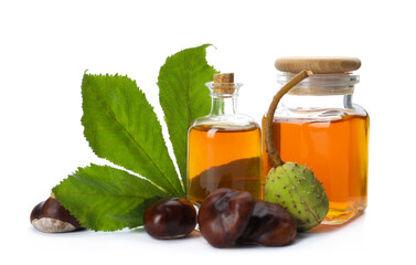 Horse chestnuts, bottles of tincture and green leaf on white background