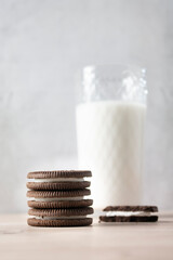 Chocolate cookies with a glass of milk on a wooden table