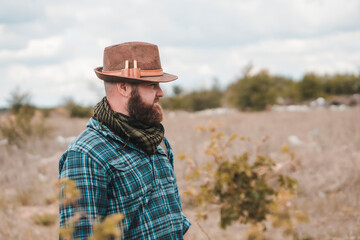 Portrait of a young bearded man in a hat