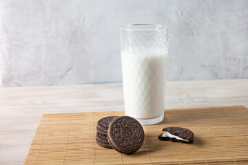 Chocolate cookies with a glass of milk on a wooden table