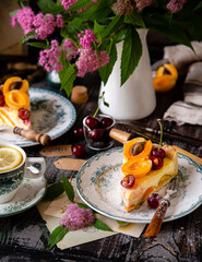 homemade two tasty slices of cottage cheese pie or cheesecake with apricots and cherries on top. selective focus
