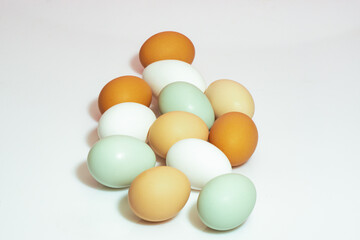 Organic eggs of different colors on a white background 
