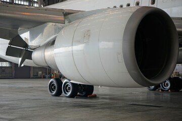 Industrial theme view. Repair and maintenance of aircraft engine on the wing of the aircraft in the warehouse - 飛行機のエンジン 羽