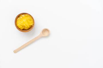 Golden honey in the wooden bowl with dipper
