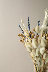 Dried flowers in vase against light background © New Africa