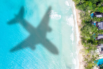 Fototapeta na wymiar Travel traveling vacation sea symbolic picture airplane flying copyspace copy space Seychelles beach water