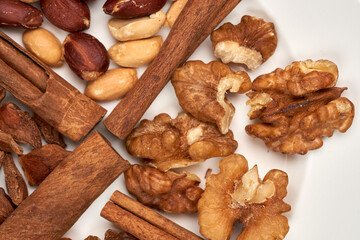 Macro Shooting still life. Peanuts, walnuts, raisins, star anise are separated by their cinnamon sticks.