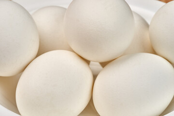 White clean chicken eggs in a plate. Close-up. Selective focus