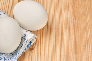 Close up of white chicken eggs on a wooden table. Selective focus