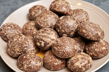 Fresh chocolate gingerbread cookies on a large platter, close-up.
