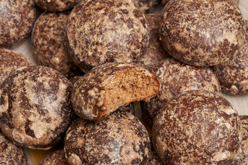 Heap of chocolate gingerbread close-up. One bitten gingerbread.
