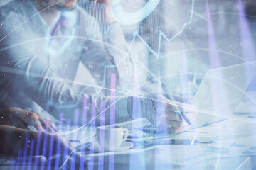 Multi exposure of man and woman working together and financial chart hologram. Business concept. Computer background.