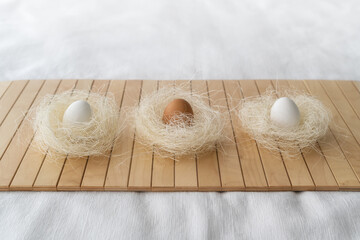 Easter concept. Easter decoration with eggs in natural color on a bamboo mat
