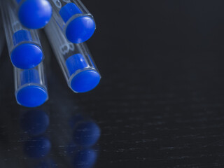 Pile of plastic blue pens close up with white background