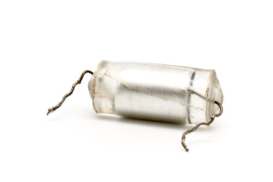 faulty High-voltage capacitor POV 390 pF 10Kv. Defective capacitor removed for replacement. isolated on white base