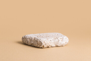 Podium for small products, cosmetics, jewelry or perfumes against beige background. Mock up.	