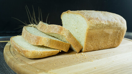 Slised loaf of fresh bread.  Homemade white bread