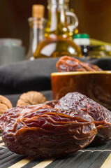 Big luxury dried date fruit on the bamboo mat, kurma ramadan kareem concept, close up.