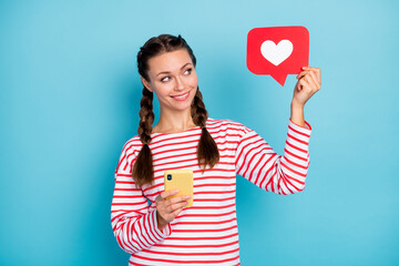 Photo of young girl happy smile use smartphone look paper card reaction icon like isolated over...