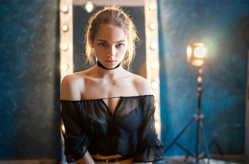 Girl in black in the studio light