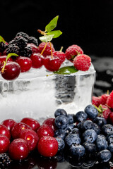 Summer berries, raspberry, blueberry, cherry, blackberry on ice 