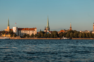 Fototapeta na wymiar Riga old town in Latvia, Europe, view from the water in summer, golden hour