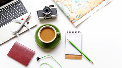 Traveler planning vacation trip and searching tourist attraction and information or booking hotel on laptop with accessories item women and map, old camera.  