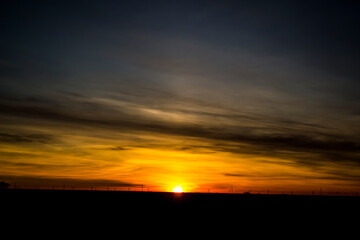 Fototapeta na wymiar Winter sunset in Kazakhstan, rustic zakt in the field.