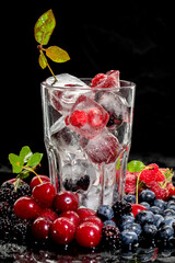 Raspberry, blueberry, cherry in cocktail 