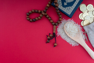 Holy Quran, Coins,Rosary and rice. Zakat concept. Zakat is a form of alm-giving as a religious obligation