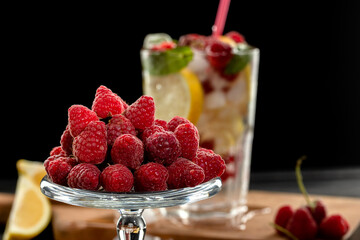 Summer cocktail with raspberry, lemon and mint leaves