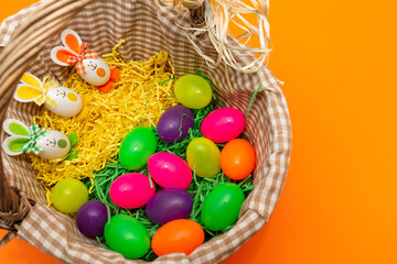 Fototapeta na wymiar Basket Colorful Easter eggs bunny ears. Funny Easter concept.