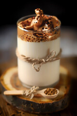 Soft focus. Dalgona coffee on a wooden stand. Trending coffee drink.