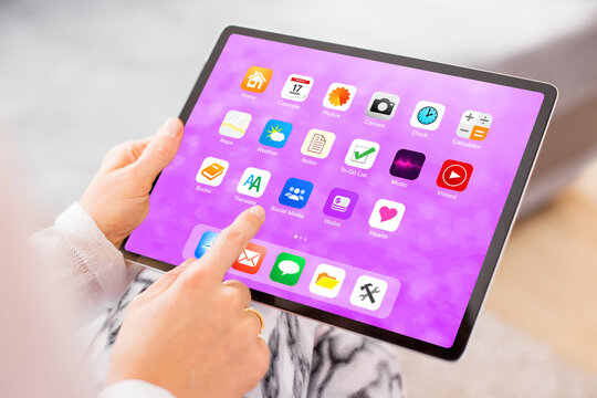 Woman holding in hands and using tablet computer