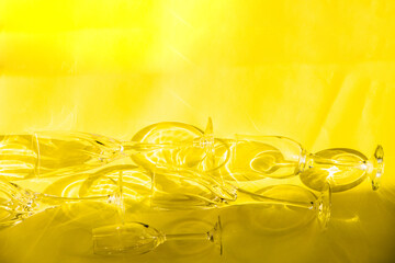 Empty glasses stand on a yellow background, top view.