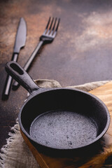 Frying pan on a cutting board. Vintage kitchenware kitchen utensils.