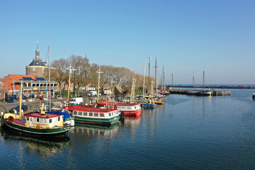 Drone photo of the harbor of Enkhuizen with colored fishing boats