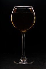 amber or orange wine made from white grapes. in a tall wine glass. Georgian national wine according to old technology. in a low key