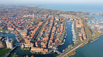 Fototapeta premium Aerial drone photo of the beautiful historic city of Enkhuizen, with old town marina harbors in the Netherlands 