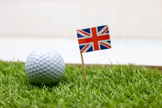 Golf ball with Union Jack Flag on green grass