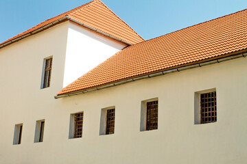 red tile roof on an old house with latticed windows
