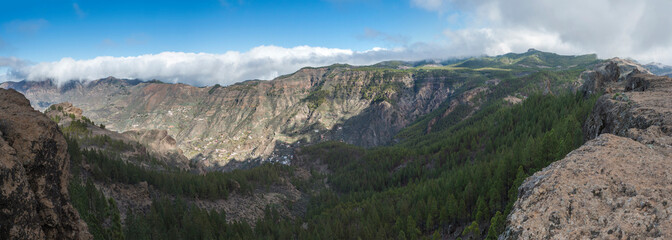 Panoramic view from Roque Nublo plateau on central volcanic mountains with Caldera and Barranco de Tejeda and Roque Bentayga rock. Gran Canaria, Canary Islands, Spain.