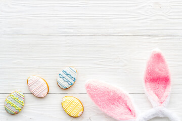 Happy Easter. Bunny ears with colorful eggs cookie, top view