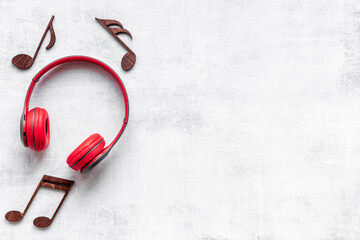 Red headphones with musical notes. Listen to the music concept
