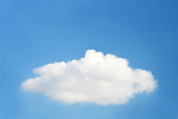 Single fluffy cloud on blue sky