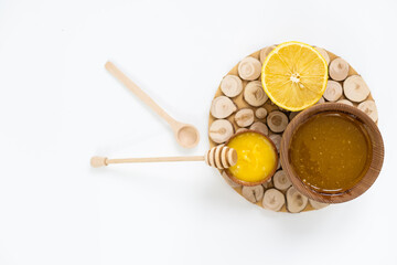Honey and lemon on a white background