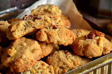 Banana cookies with nuts in a box on a wooden background