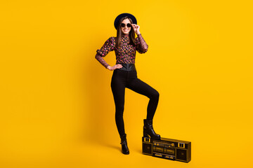 Fototapeta na wymiar Full length body size photo of female student listening to music on retro boombox isolated vivid yellow color background