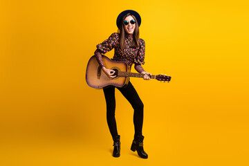 Obraz premium Full length body size photo of happy brunette playing acoustic guitar overjoyed singing song isolated bright yellow color background
